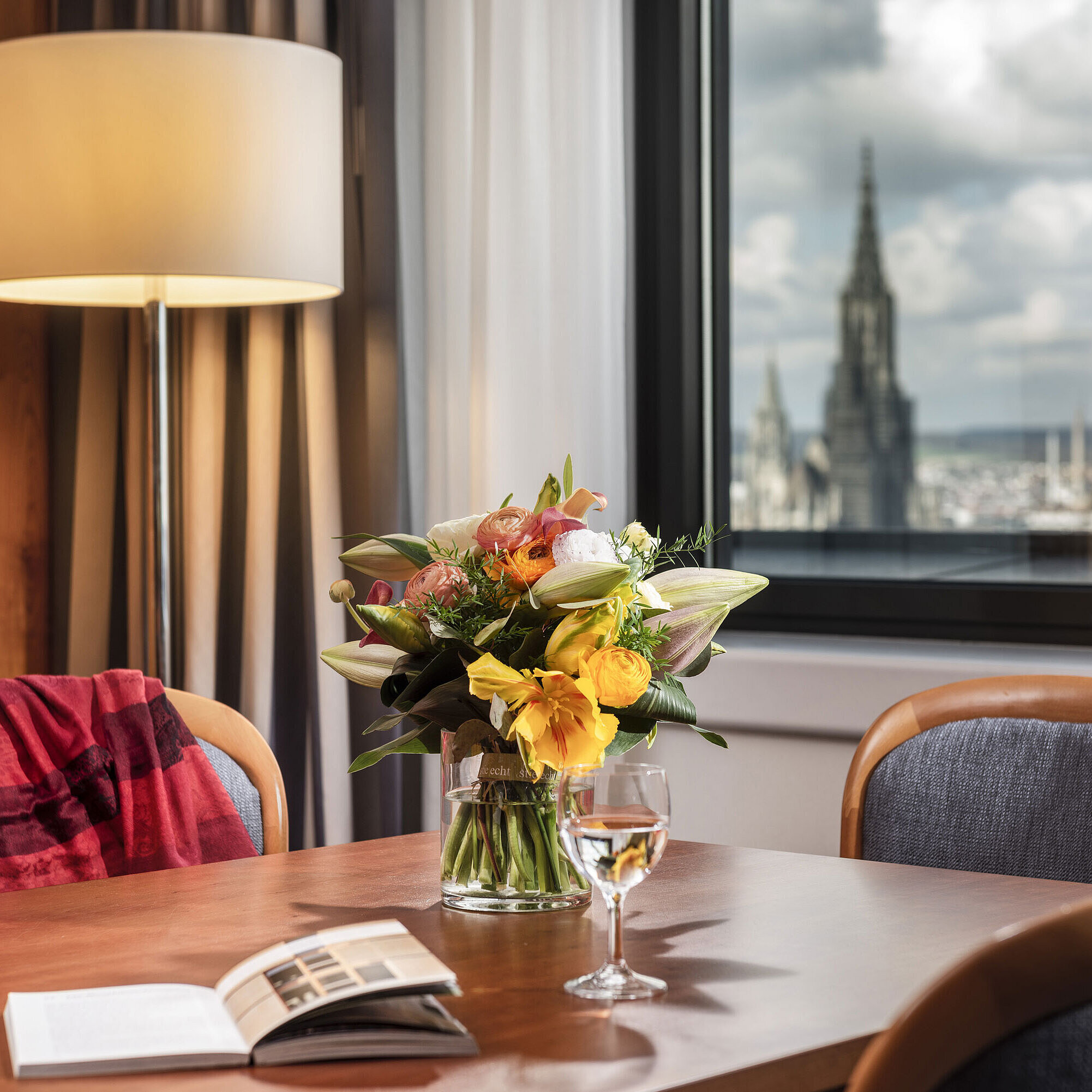 Detailansicht Junior Suite Tisch mit Blumenstrauß in der Junior Suite im Maritim Hotel Ulm mit Blick auf das Ulmer Münster
