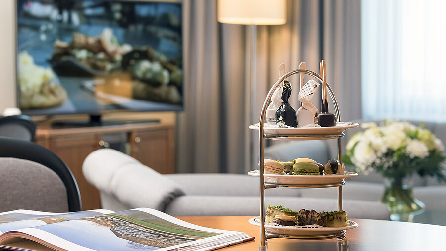 Stilvolle Lounge mit Etagere voller süßer Köstlichkeiten in der Junior Suite des Maritim Hotel Hannover.