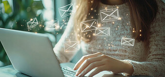 Frau arbeitet am Laptop mit digitalen Symbolen für E-Mail-Kommunikation im modernen Büro