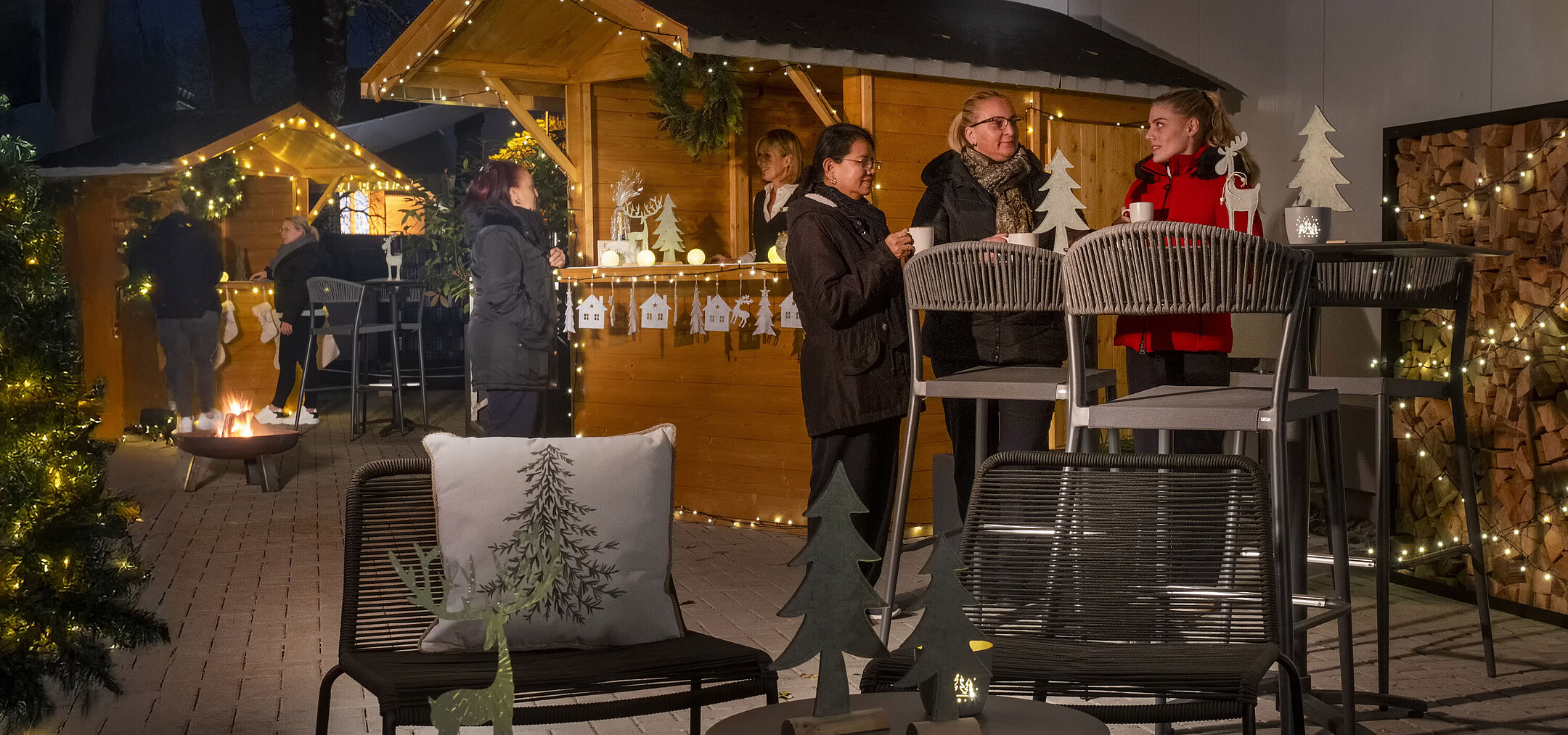 Maritim Weihnachtsdorf Belebter Weihnachtsmarkt im Maritim Hotel Darmstadt mit Gästen, festlich dekorierten Hütten und stimmungsvoller Beleuchtung.