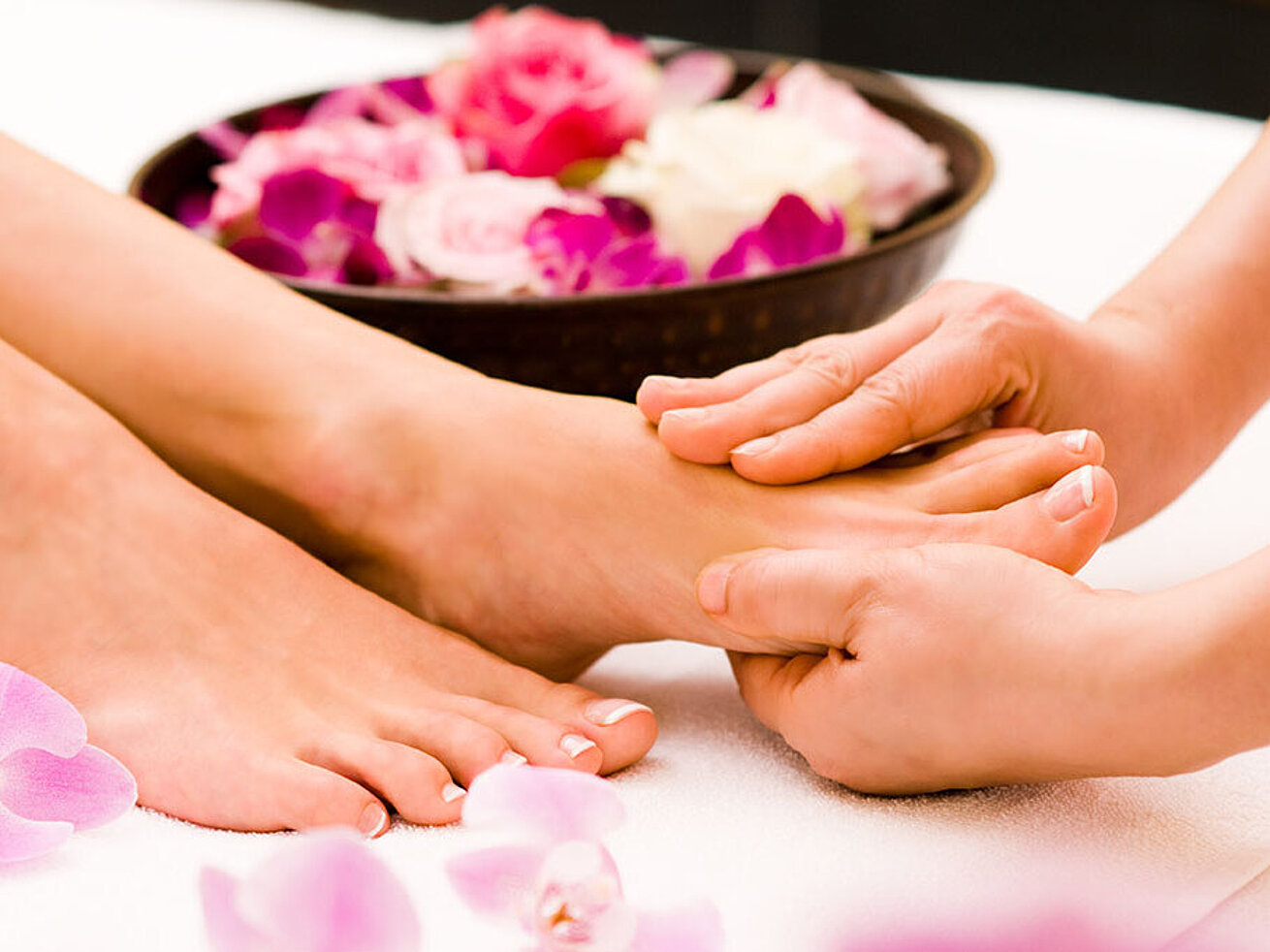 © Jonas Glaubitz - AdobeStock.com Fußmassage mit Blüten im Spa für Entspannung