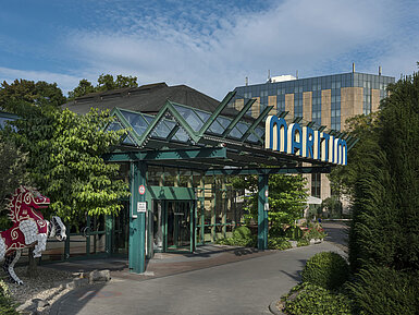 Haupteingang des Maritim Hotel Stuttgart mit Glasdach, grünem Eingangsbereich und Maritim-Schriftzug