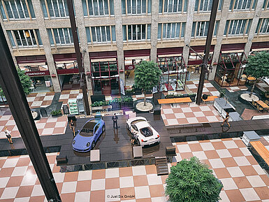 Lobby in Köln Eventfläche mit zwei Autos auf Bühne in moderner Indoor Location