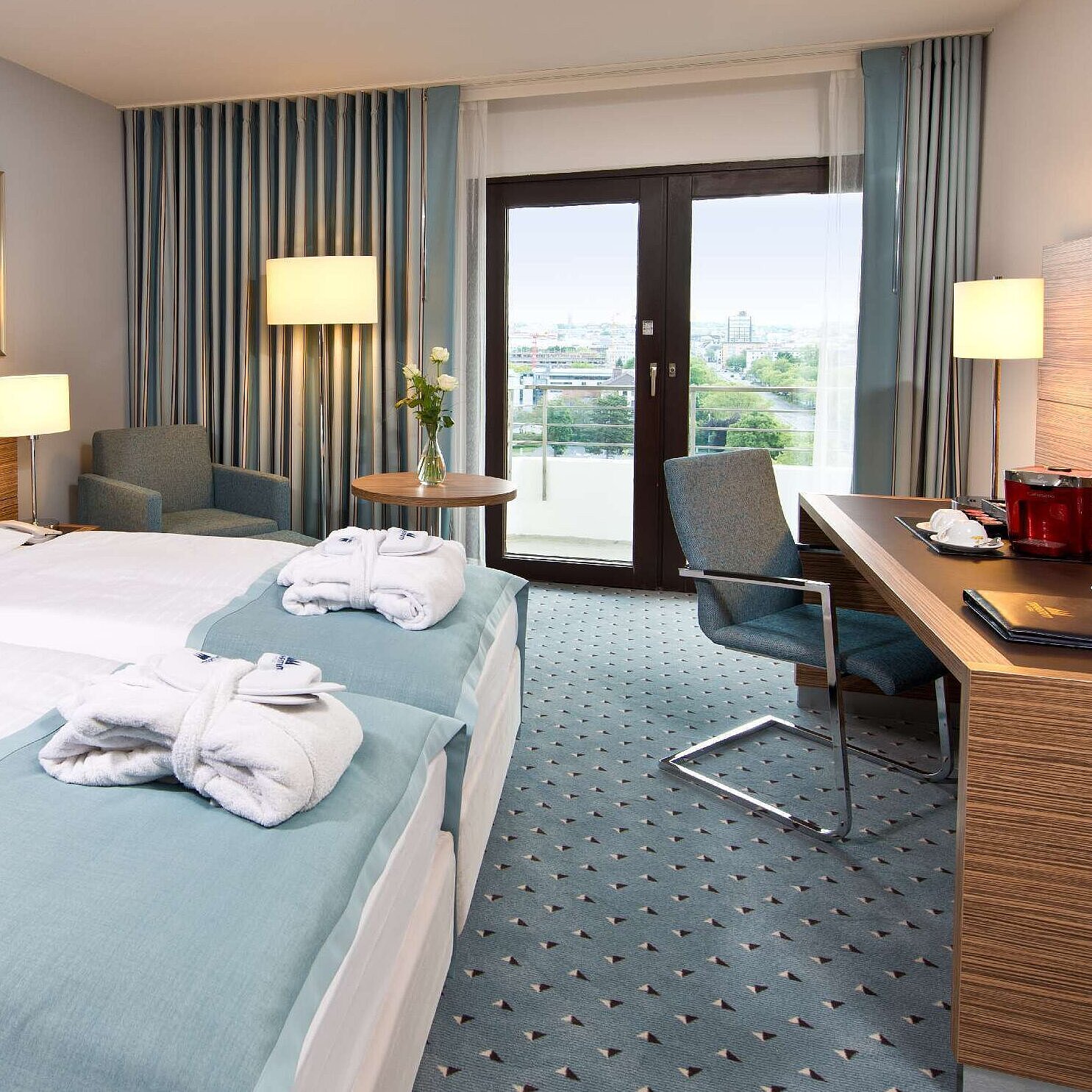 Superior Zimmer im Maritim Hotel Darmstadt mit stilvollem Design, Schreibtisch, Sitzecke und Doppelbett mit Bademänteln.