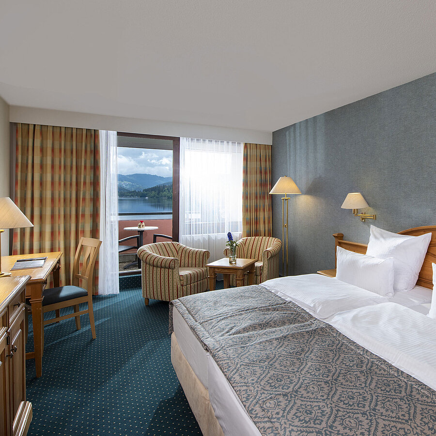 Geräumiges Zimmer im Maritim TitiseeHotel mit Sitzgruppe und Blick auf den Titisee