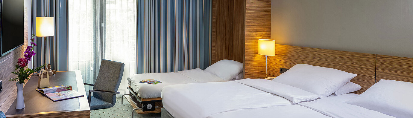 Comfort Familienzimmer im Maritim Hotel Darmstadt mit Doppelbett, Zustellbett und modernem Arbeitsbereich