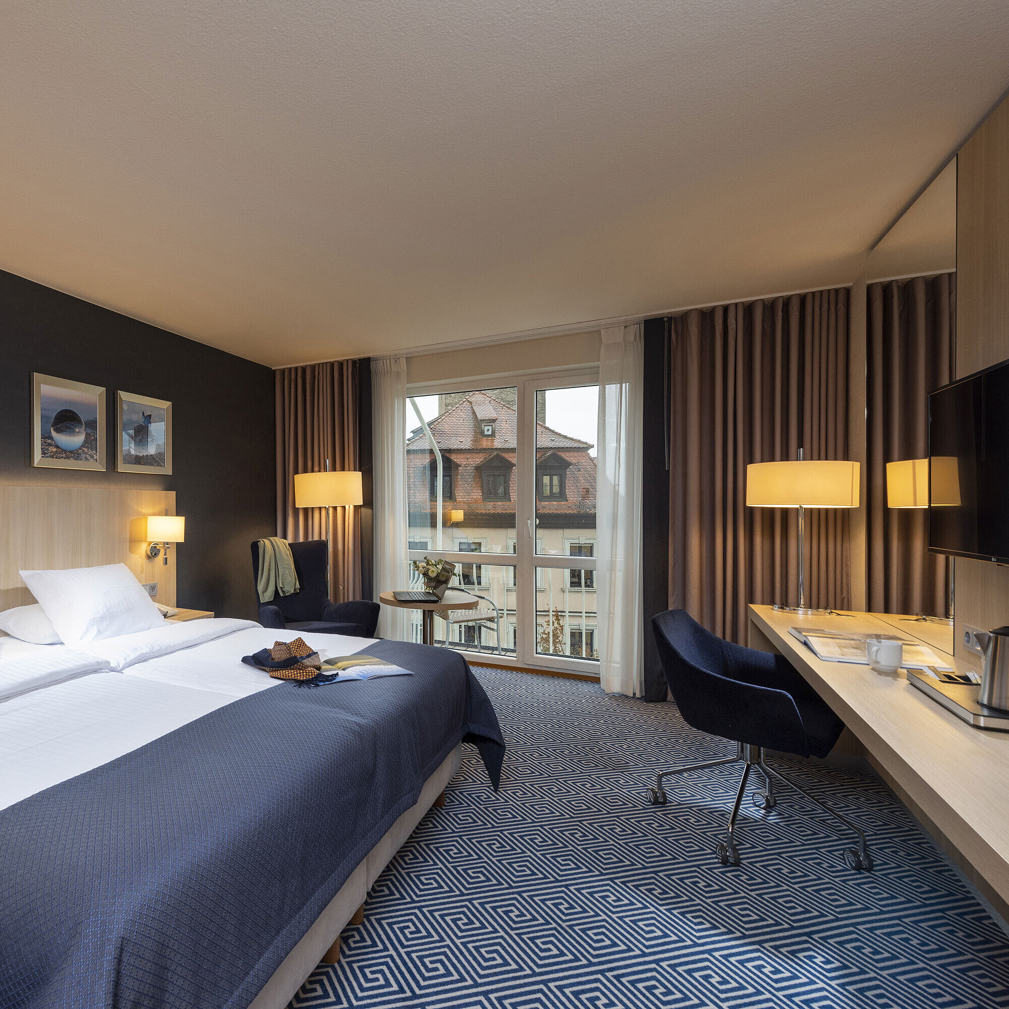 Superior Zimmer Elegantes Superior Zimmer im Maritim Hotel Würzburg mit großem Doppelbett und Ausblick auf historische Dächer