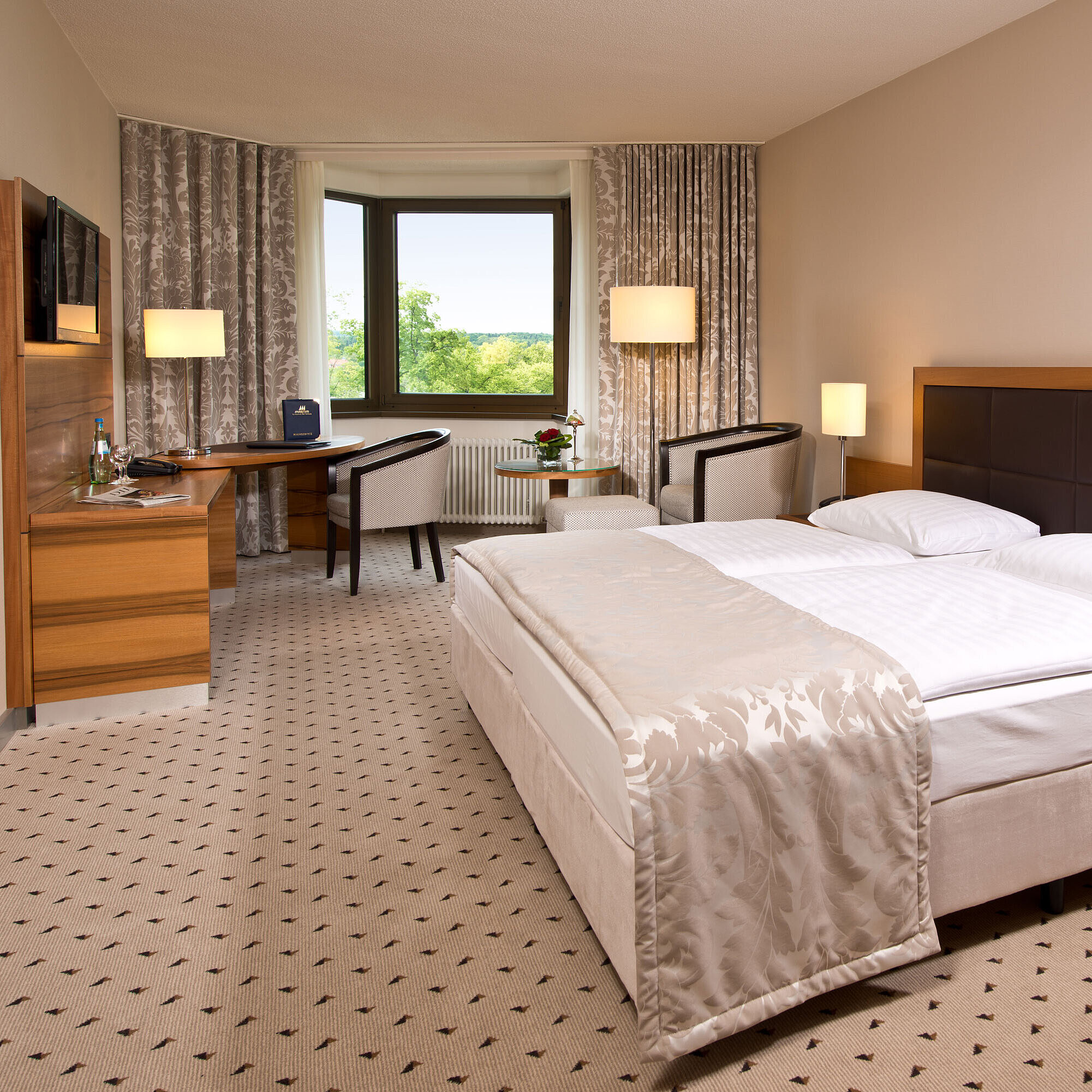 Komfortables Hotelzimmer im Maritim Hotel Bad Homburg mit modernem Design und Blick ins Grüne.